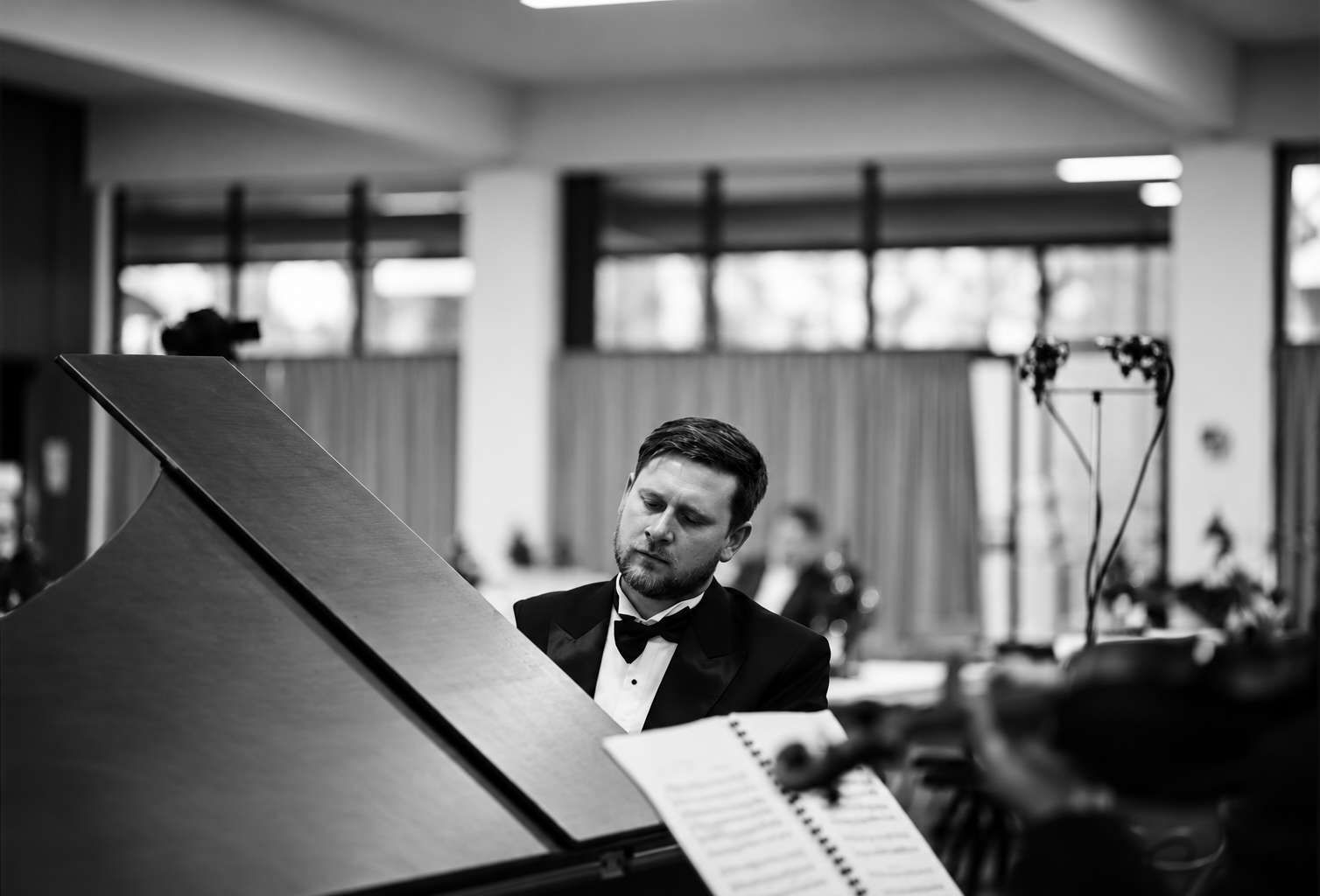 James Doig at a grand piano in a black and white photograph